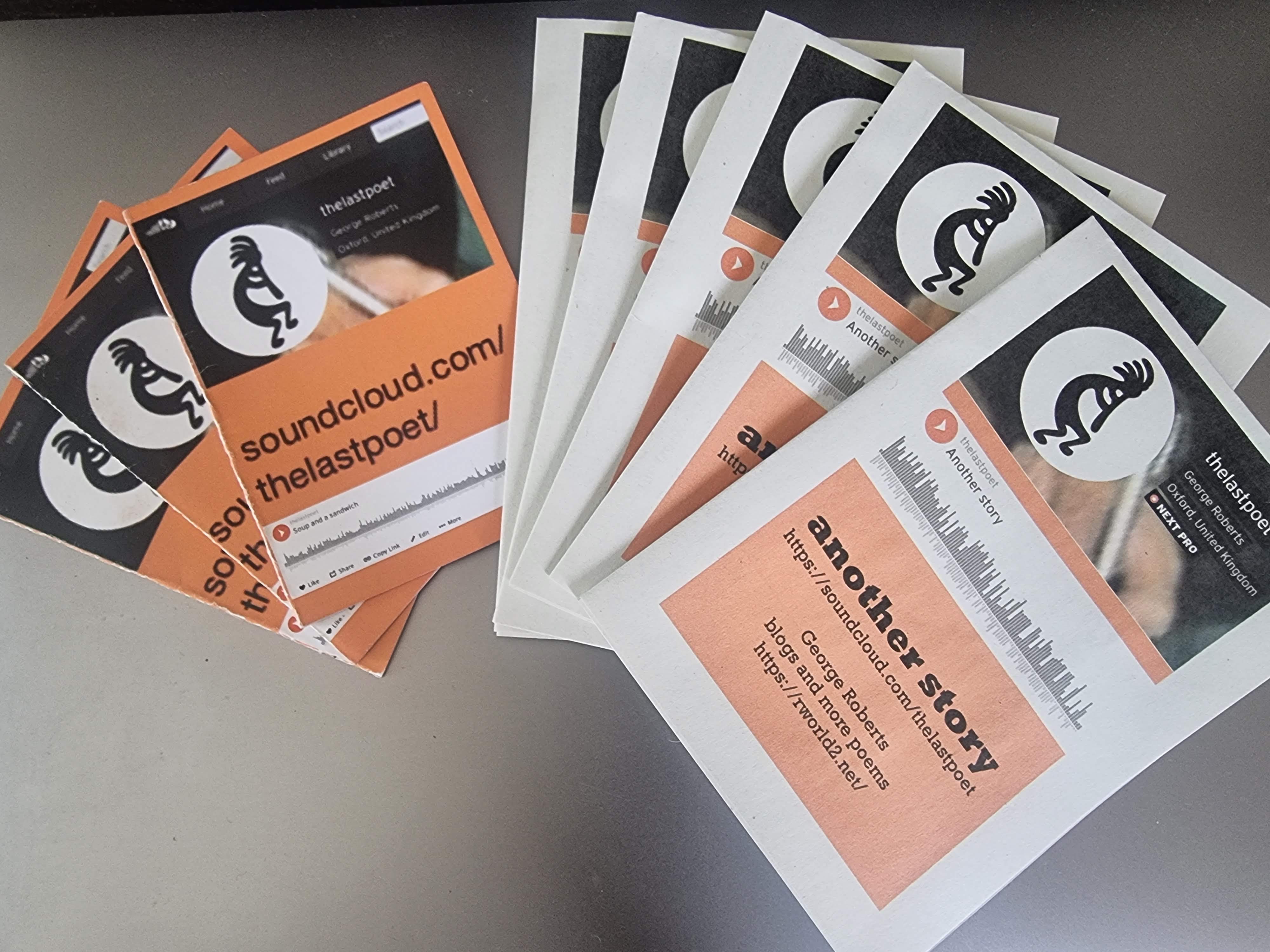 Photo illustration of two printed and folded mini pamphlets promoting my websites. The items are displayed, fanned like a hand of cards. The text on the right hand item reads, "another story". Below is the URL. (needs a QR code).